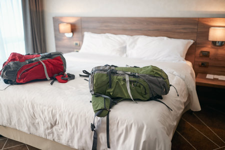 Two backpack travellers arriving to the hotel roomの写真素材