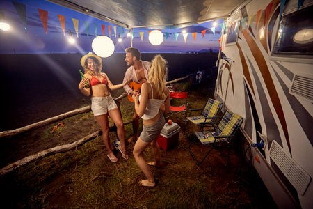Group of friends having sunset party on the beach; Casual lifestyle conceptの写真素材