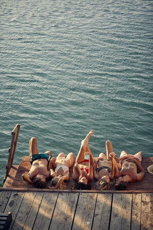 People at the lake docks. Young Friends at vacationの写真素材