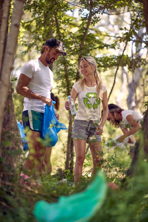 Group of people cleaning up the woodsの写真素材