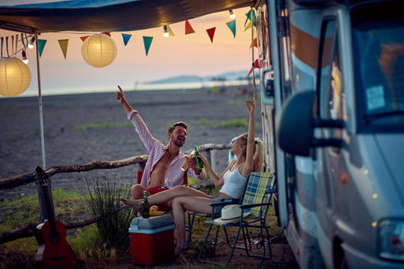 Young couple having fun camping by the sea togetherの写真素材