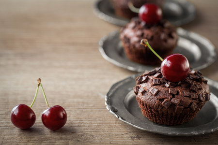 fresh cherry and sweet chocolate muffins close upの写真素材