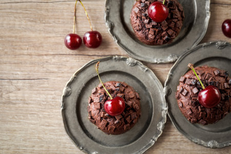 mini muffins with fresh cherry close up on the plateの写真素材