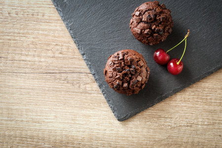 muffins with cherry and chocolate backgroundの写真素材