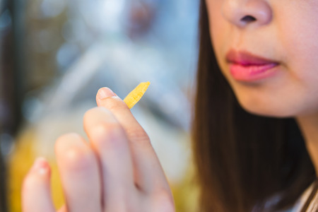 Asian woman eating snack, lifestyle conceptの写真素材