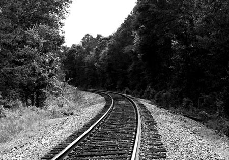 Moderately curved railroad tracks - black and whiteの写真素材