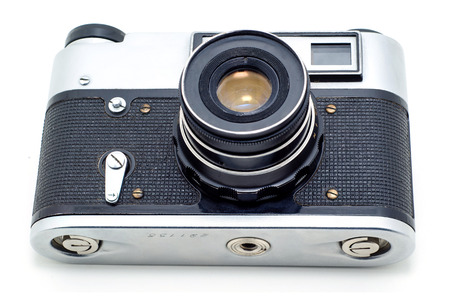 Old vintage film photographic camera isolated on white background.