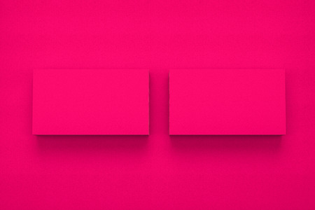 Mockup of two business cards on red textured paper studio. High resolution 3d render.