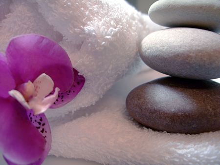 Towel, stacked massage stones, flower of orchid - elements of spa therapyの写真素材