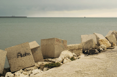 Far lone boat in a cloudy day.の写真素材