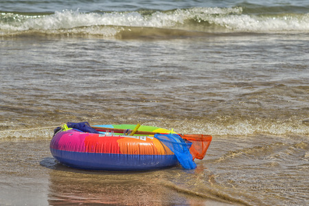 Colored lifebelt at seashoreの写真素材