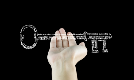 Business vocabulary sort themselves into the shape of the key on palm.の写真素材