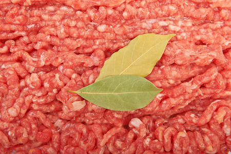 Raw pork meat ground beef with bay leaf on white background.