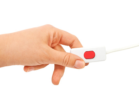 Hand holds the switch with a red button. Isolated on white