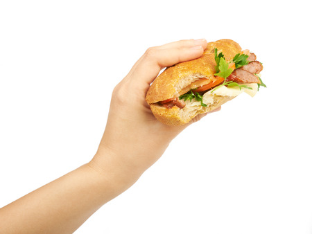 Sandwich in hand isolated on white backgroundの写真素材