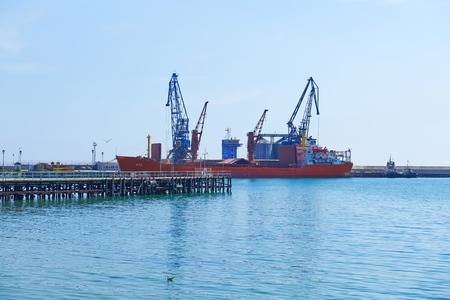 Big ship loading freight containers at the port of Balchik in Bulgaria