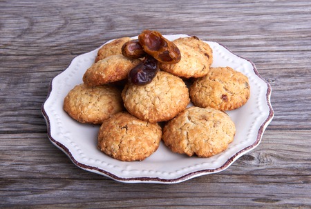 Oatmeal cookies tasty breakfast on the plate on a wooden backgroundの写真素材