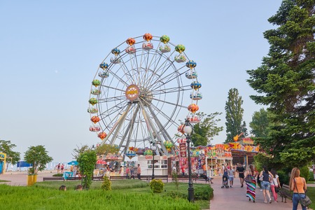GOLDEN SANDS, BULGARIA - June 06, 2017: Large beautiful Ferris wheel with tourists on the pedestrian promenade in Golden Sands, Bulgariaのeditorial素材