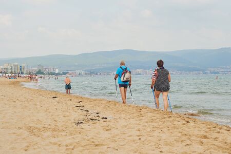 SUNNY BEACH, BULGARIA - September 9, 2018: Old people walk on the beach, Popular summer resort near Burgas, Bulgaria - view of the beach in summerのeditorial素材