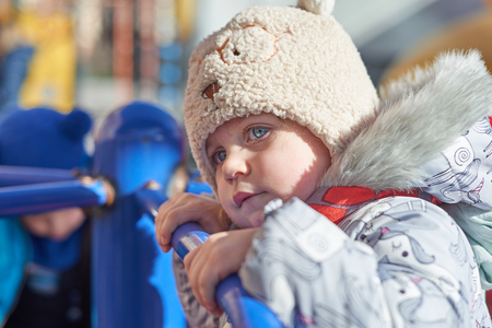 Active little girl on playground - closeup shotの写真素材