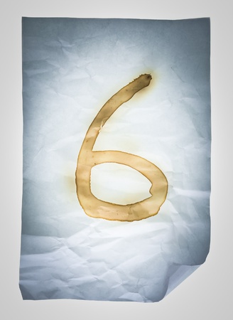 Burned number six on Crumpled paperの写真素材