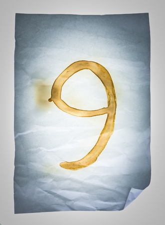 Burned number nine on Crumpled paper