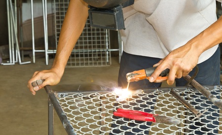 Worker welding steel