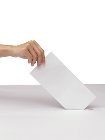 Lady hand putting a voting ballot in slot of white box isolated on whiteの写真素材