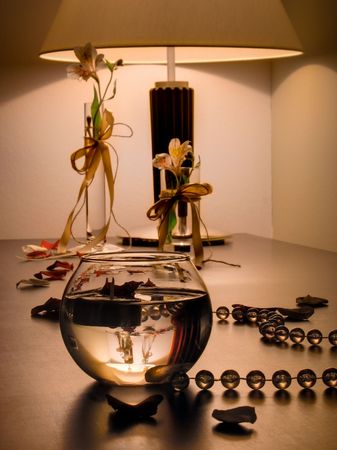 Bow and beads with rose petalsの写真素材