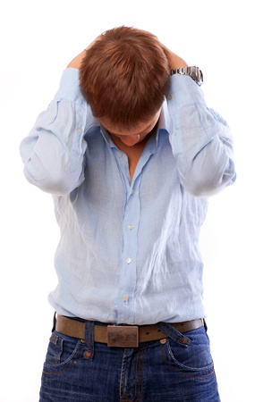 Portrait of a unhappy young businessman isolated over whiteの写真素材