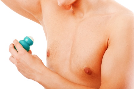 Closeup of a young muscular man using an antiperspirant isolated over whiteの写真素材