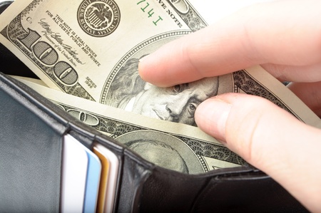 hands taking money from open wallet isolated