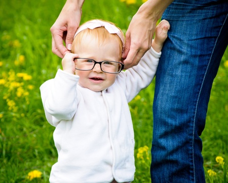 Funny little baby with glasses - outdoorの写真素材