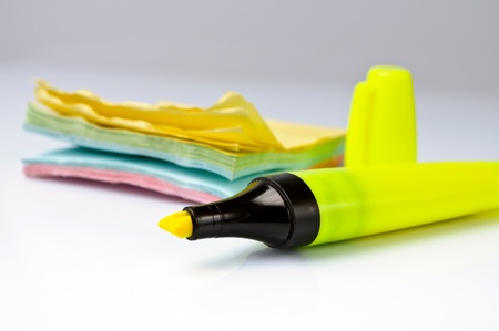 Yellow marker with a stickers on a backgroundの写真素材
