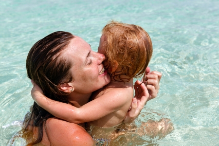 Mother with little daughter on the beachの写真素材