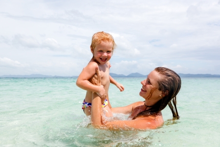 Mother with little daughter on the beachの写真素材