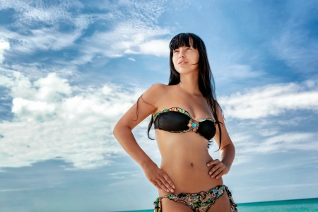 Brunette beautiful model posing on a tropical beachの写真素材