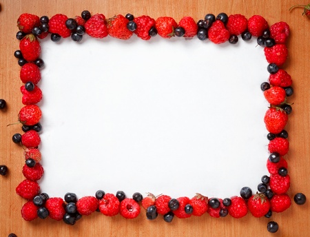 Colorful border frame made of sweet forest berriesの写真素材