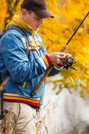 Fisherman with spinning - autumn fishing season.の写真素材
