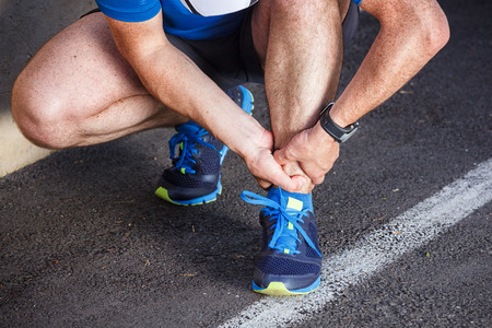 Broken twisted ankle - running sport injury.の写真素材