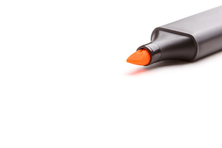 Orange highlighter pen isolated over white.の写真素材
