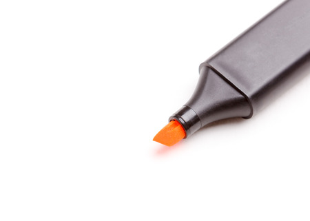 Orange highlighter pen isolated over white.の写真素材
