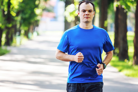 Young man running outdoors in the morning.の写真素材