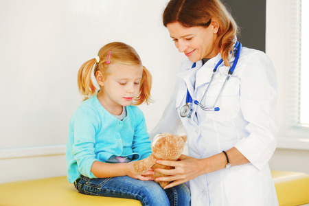 Pediatrician doctor examining little girl.の写真素材