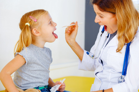 Pediatrician doctor examining little girl.の写真素材