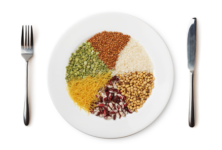 Plate with different cereals and garnish isolated on white background.の写真素材