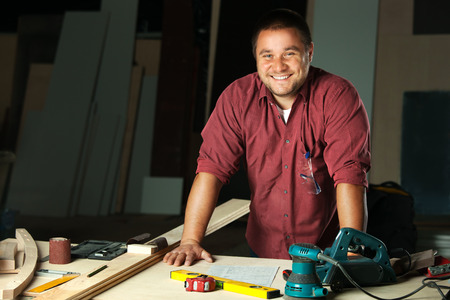 Portrait of happy professional carpenter at his work place.の写真素材