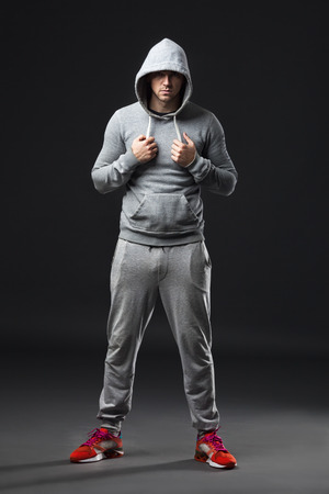 Studio portrait of cool looking young guy in sportswear.の写真素材
