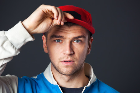 Studio portrait of cool looking young guy posing in studio.