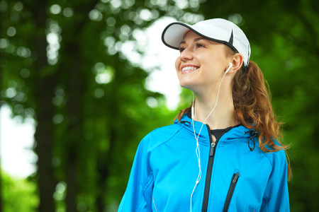 Portrait of cheerful young woman ready to start her morning running session.の写真素材